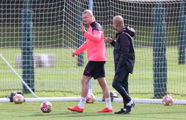 Erling Haaland échangeant avec Pep Guardiola pendant un entraînement de Manchester City, pour illustrer la préparation, la concentration et la productivité.